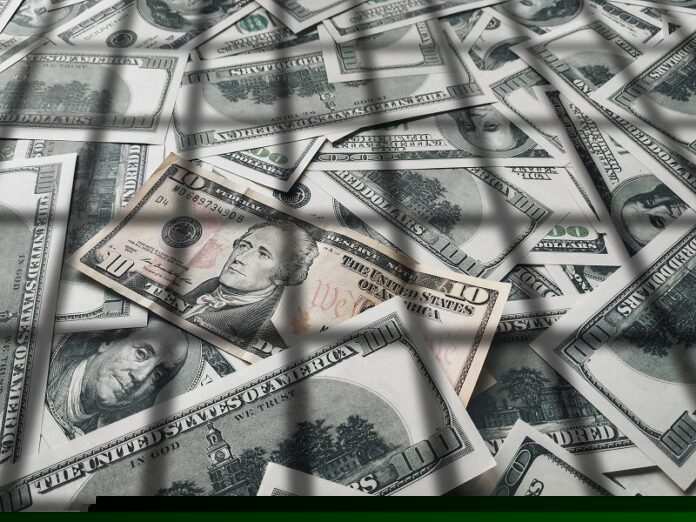 Shadow from the lattice on dollar bills. The concept of prison, the penalty for money laundering, theft, crime and the penalty for tax evasion. Corruption and counterfeiting.