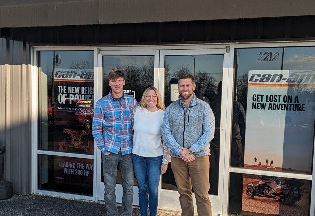Sellers with Buyer at MotoGear Warehouse storefront
