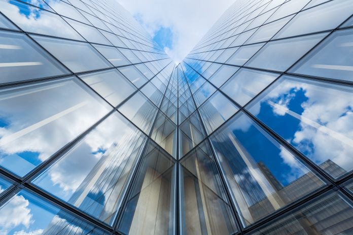 Blue sky and clouds reflections on a glass building