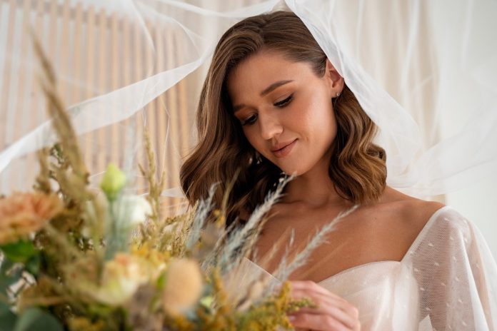 side-view-beautiful-ukrainian-bride-holding-flowers