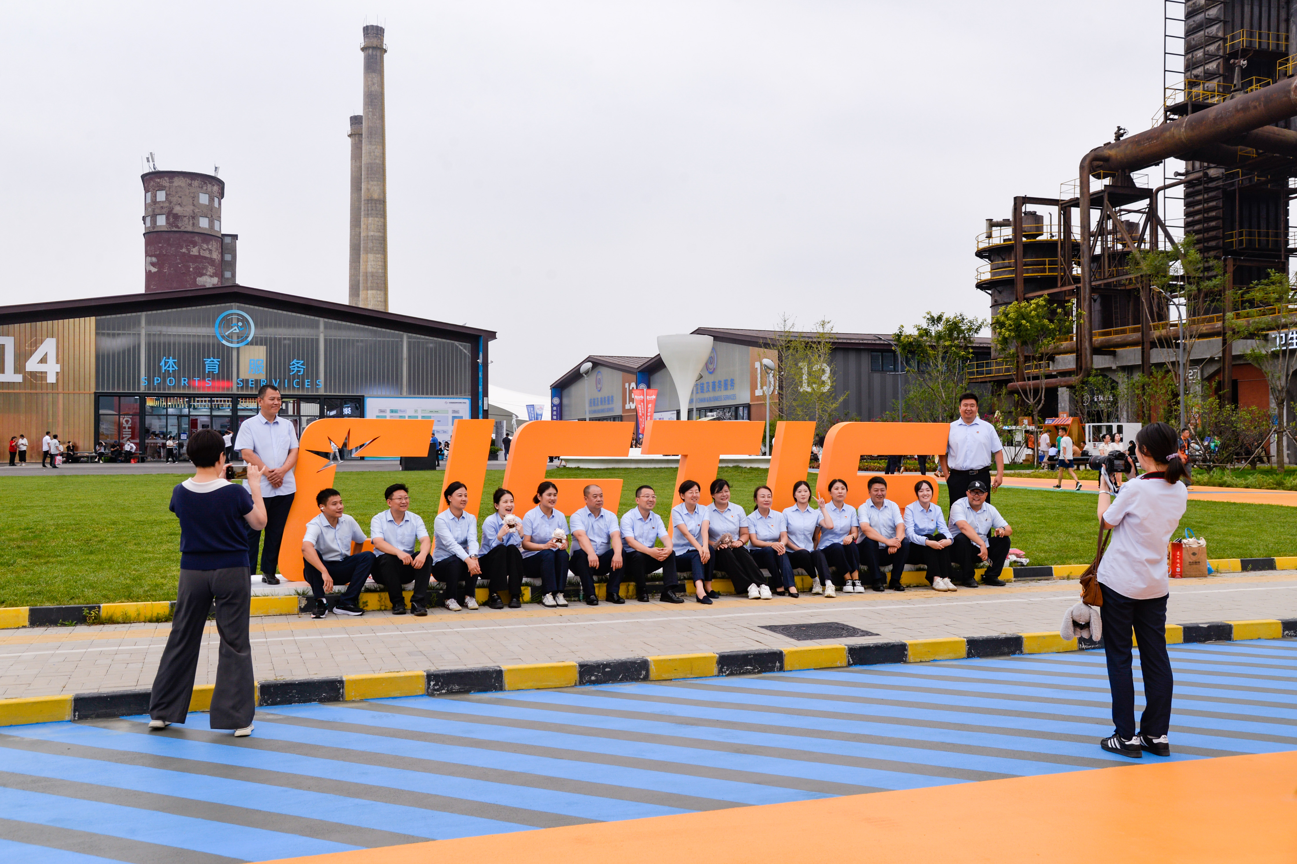 Catption: Staff members take photos with a sign of the 2025 China International Fair for Trade in Services (CIFTIS) in Beijing, capital of China, Sept. 10, 2025.