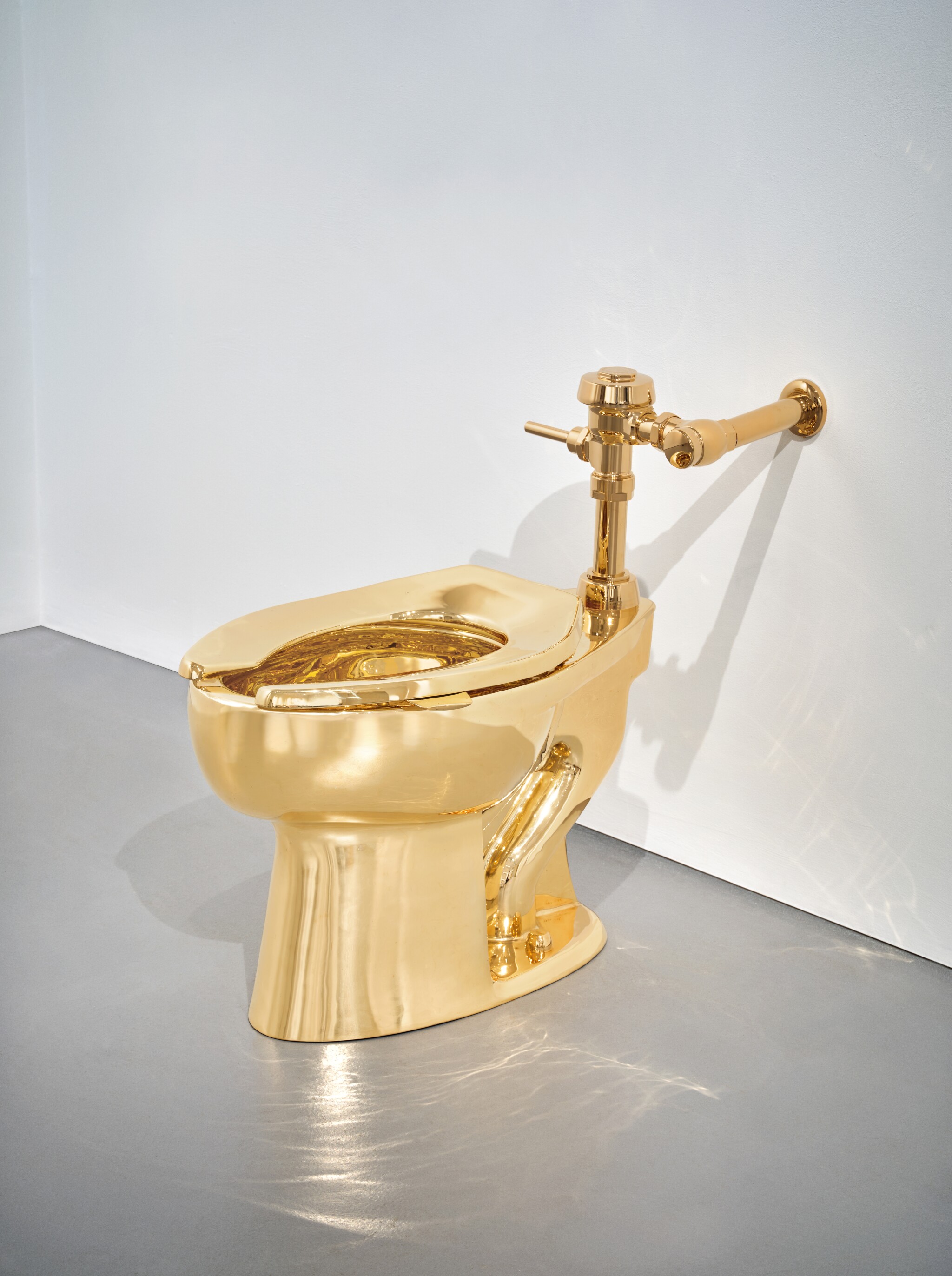 Solid Gold Toilet by Maurizio Cattelan