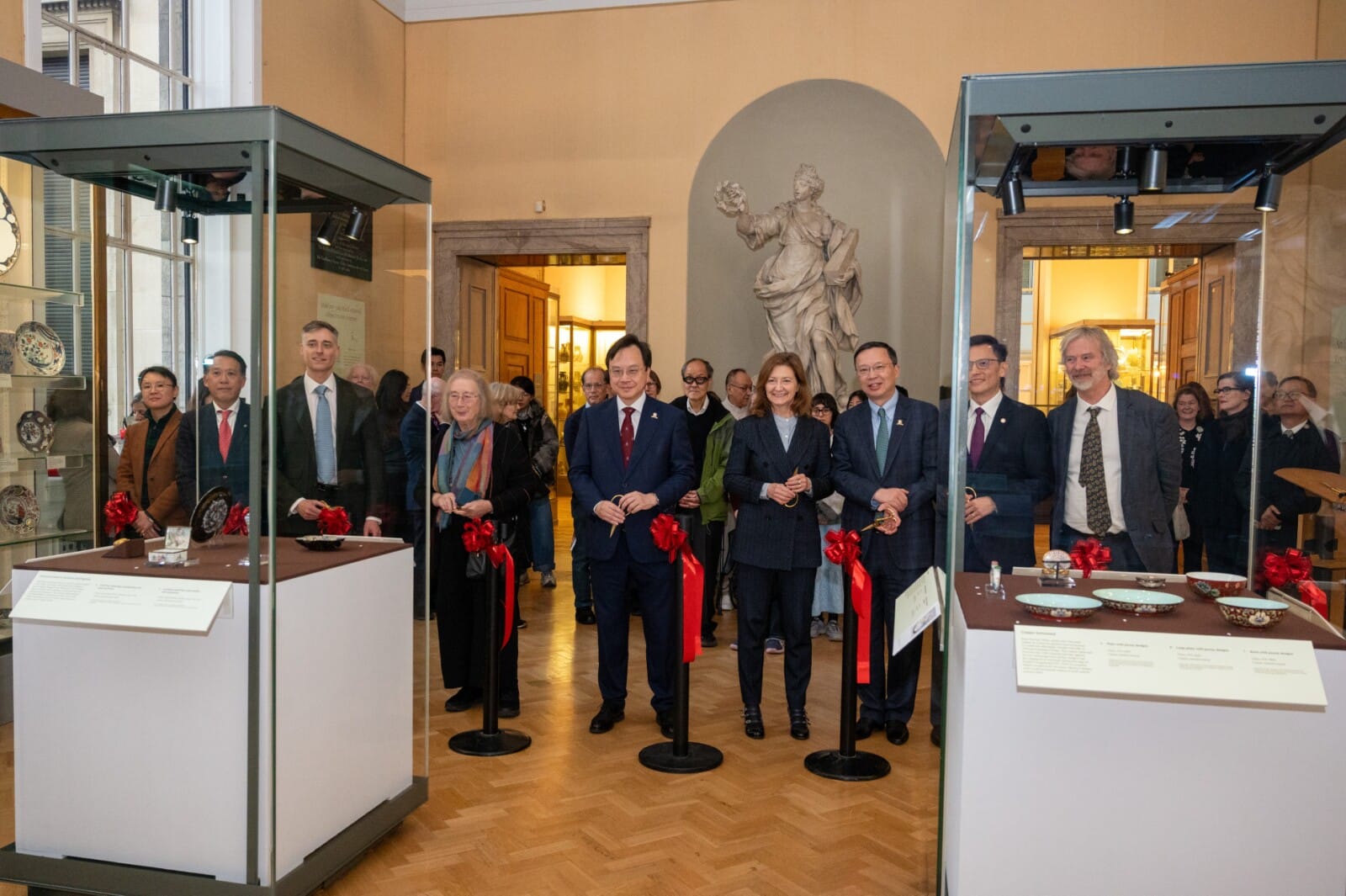 Officiating guests hosted the ribbon-cutting ceremony during the opening ceremony of the special exhibition "An Enamel Revolution: China and the World", jointly presented by the CUHK Art Museum and The Fitzwilliam Museum, University of Cambridge. From left: Dr Joyce Chou, Research Associate of the CUHK Art Museum; Dr James Lin, Senior Curator of Chinese Art at The Fitzwilliam Museum; Professor Henning von Mirbach, Assistant Professor of Early Modern Chinese Art in the Department of History of Art, University of Cambridge; Professor Dame Jessica Rawson, former Warden of Merton College and Pro-Vice-Chancellor of the University of Oxford; Professor Dennis Lo Yuk-ming, CUHK's Vice-Chancellor and President; and Professor Deborah Prentice, Vice-Chancellor of the University of Cambridge; Professor Anthony Chan Tak-cheung, CUHK's Pro-Vice-Chancellor (Alumni/Community Engagement and Institutional Advancement); Professor Josh Yiu Chun-chong, Director of the CUHK Art Museum; and Dr Luke Syson, Director of The Fitzwilliam Museum.